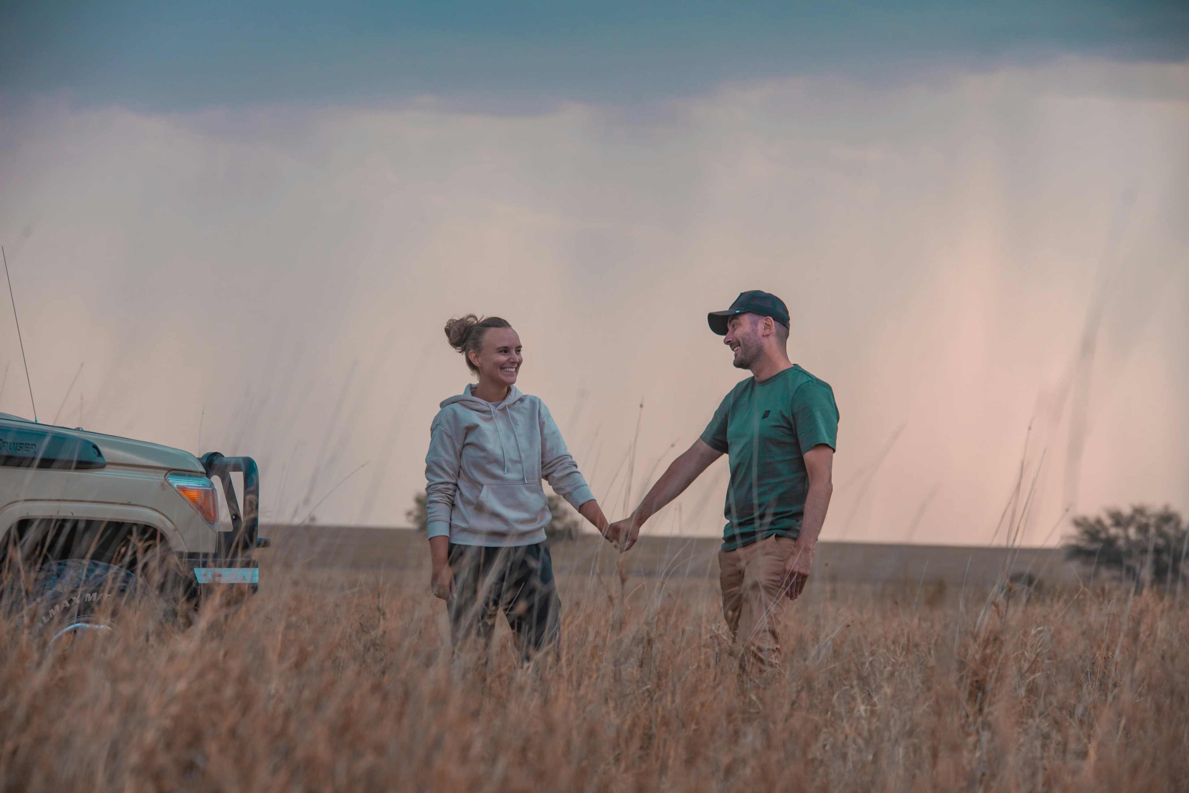 Couple holding hands on a Tanzania safari honeymoon